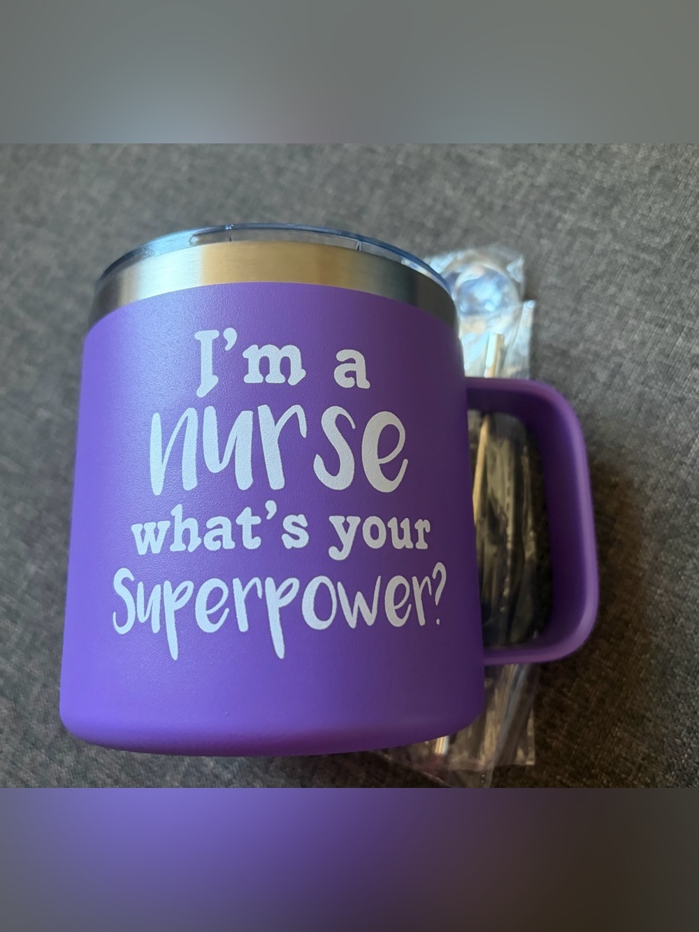 “I’m a NURSE what’s your superpower?” mug, with silver spoon and cleaning tool.
